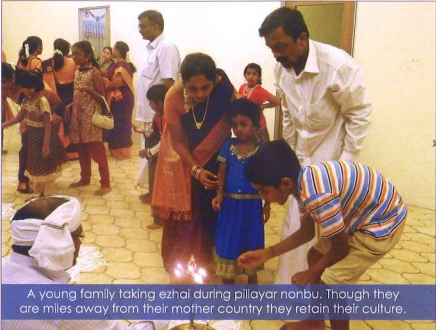 Young Nagarathar family receiving ezhai blessing during Pillayar Nonbu