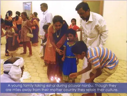 Young Nagarathar family receiving ezhai blessing during Pillayar Nonbu