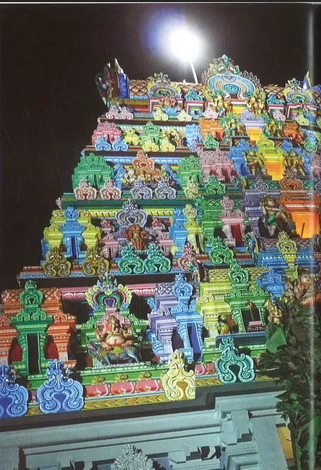 Sri Thendayuthapani Temple rajagopuram five-tier tower illuminated at night Tank Road Singapore